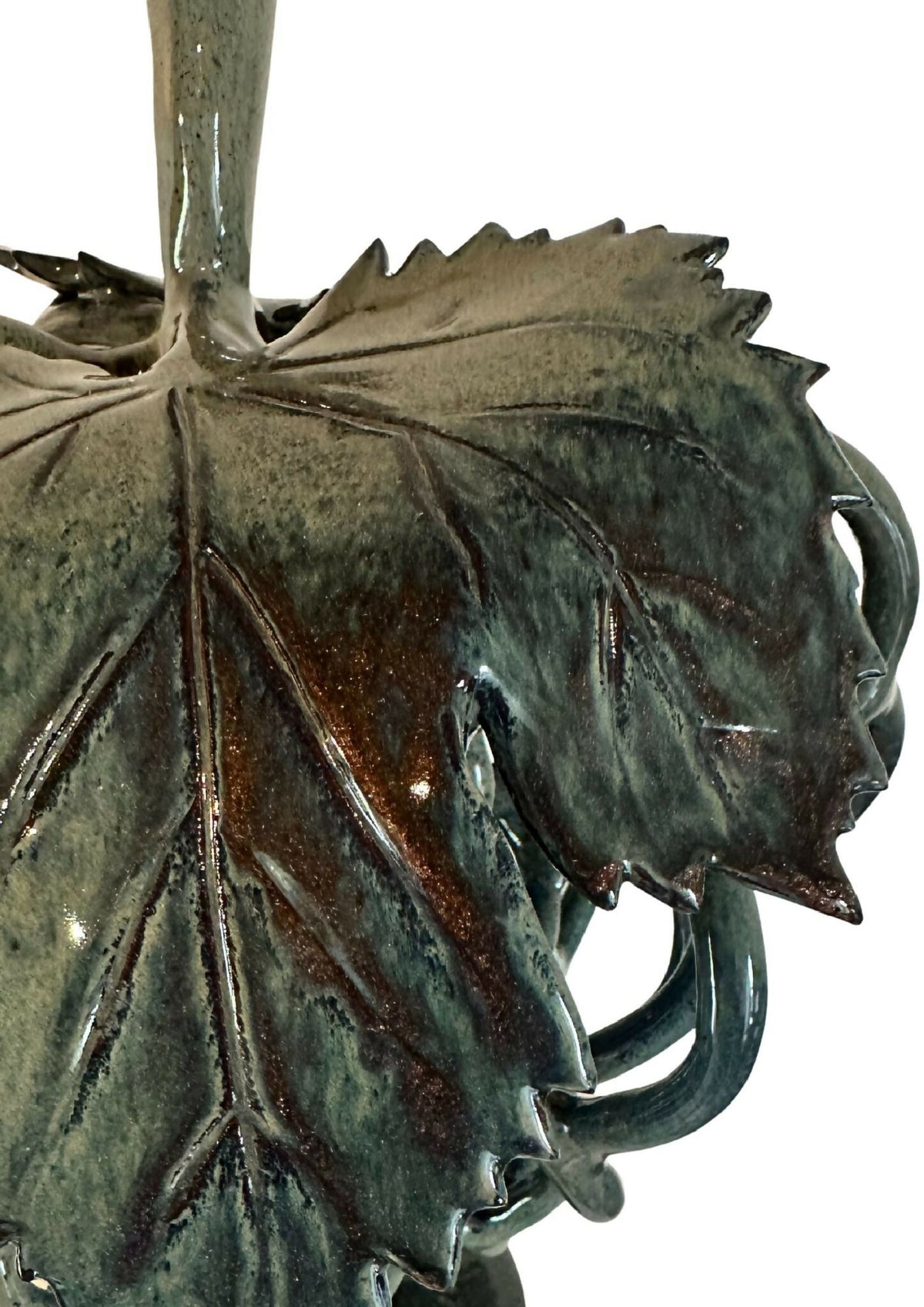 Sculpture décorative en métal patiné vert foncé, vue rapprochée de feuilles et volutes