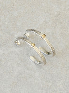 Boucles d’oreilles courbées en métal argenté, rayures verticales et détails dorés