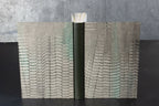 Carnet ouvert à couverture en cuir gris, motifs ondulés sur les pages