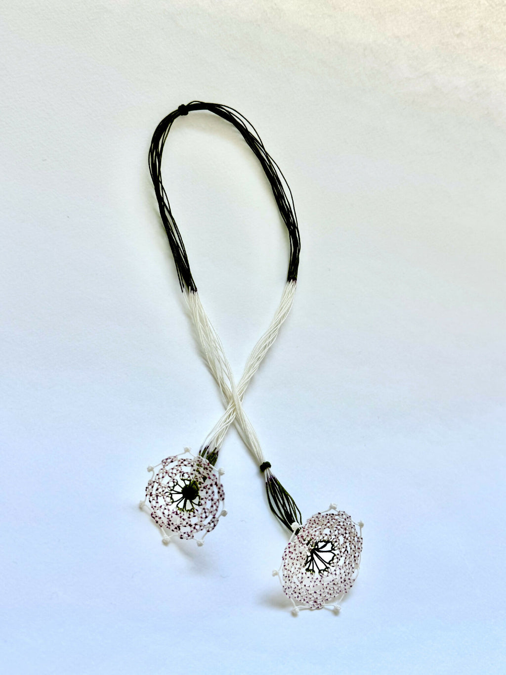Collier en soie avec deux pendentifs trèfle argentés et cordons bicolores