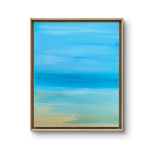 Tableau paysage bleu lagon, cadre en bois clair, teintes bleu et sable.
