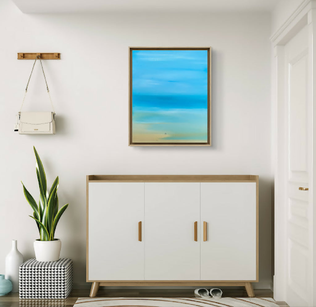 Tableau paysage bleu lagon au format carré, cadre en bois clair.