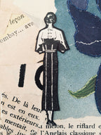 Silhouette masculine noire sur papier beige, avec fleur bleue et feuille verte autour