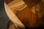 Dessus rond d’une table d’appoint en bois sculpté, bord clair et motifs