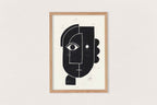 Linogravure encadrée, visage abstrait noir sur fond clair, composition géométrique