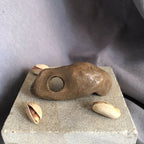 Mini bougeoir : socle en pierre avec support brun percé d’un trou, coquillages.