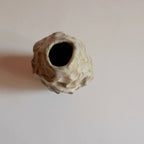 Petit vase ROC en céramique texturée, ouverture noire en forme d’anneau.
