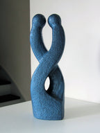 Sculpture abstraite bleue en relief, vue en angle, double ouverture centrale.