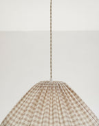 Suspension conique vichy beige clair, petits carreaux, cordon de suspension visible.