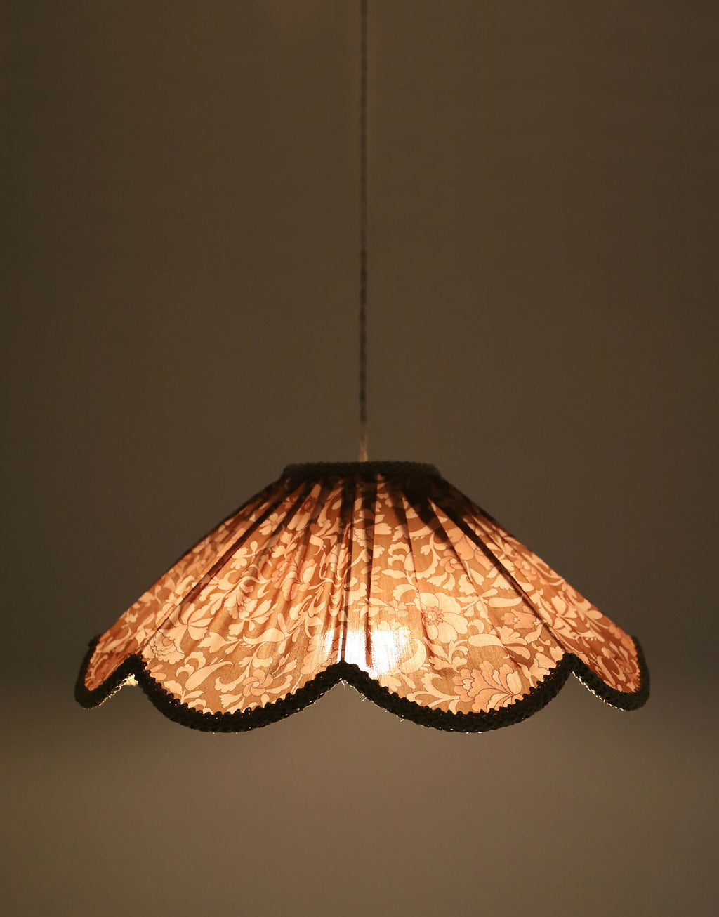 Suspension florale en tissu orange, motif fleurs, abat-jour lumineux avec bord doré.