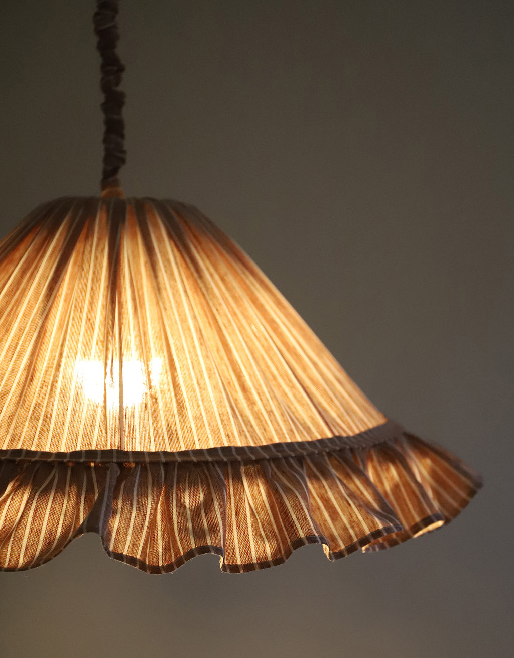 Suspension Emilia en tissu rayé terracotta et blanc à volant plissé main, fabriquée en France par Hautlalampe