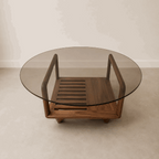 Table basse Darwin ovale : plateau en verre et piètement en bois sculpté