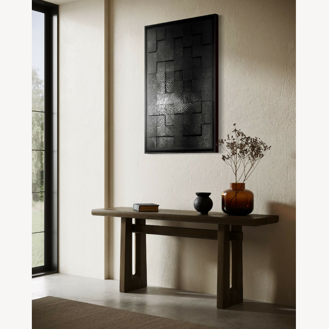 Tableau abstrait noir à formes rectangulaires en relief, bordure noire mate.
