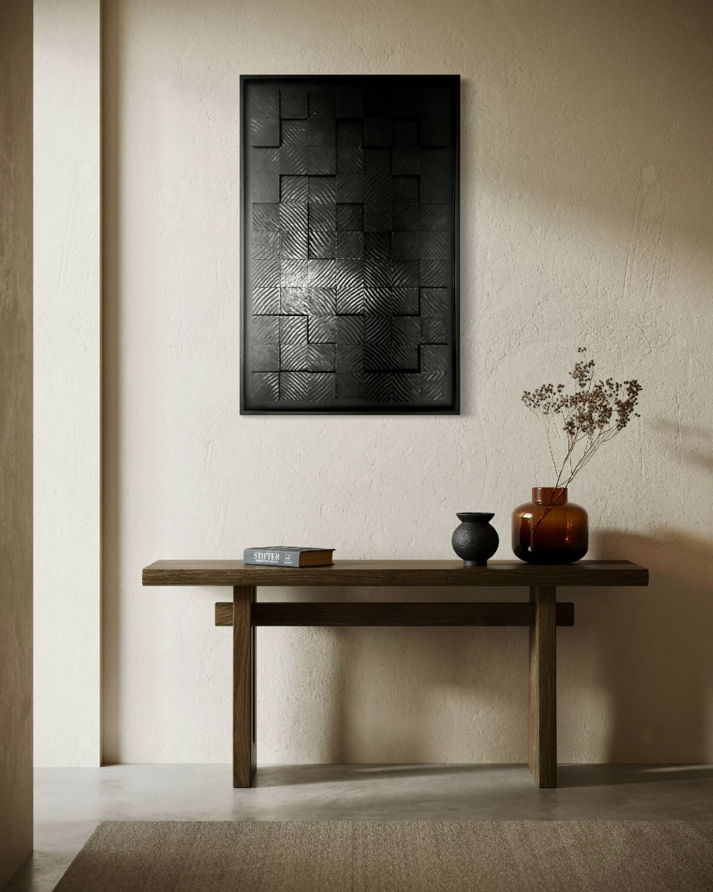 Tableau encadré à motifs carrés et rayures, teintes noir et anthracite.