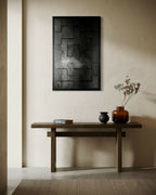 Tableau encadré à motifs carrés et rayures, teintes noir et anthracite.