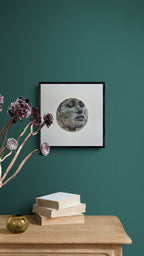 Tableau encadré vu de face avec cercle abstrait gris et noir.