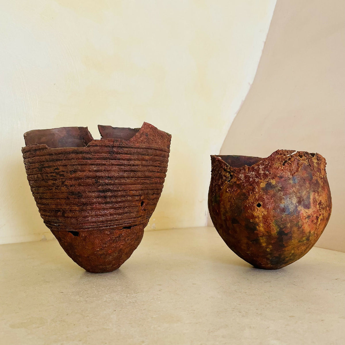 Deux bols déco en métal patiné, texture rouille, forme évasée avec bords déchirés.