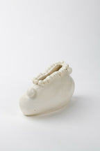 Vase en céramique blanche avec anses latérales et bord orné de petites perles