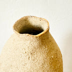 Vase en grès brut beige, gros plan de l’ouverture évasée et intérieur sombre.