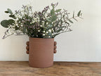 Vase en grès roux PALMA, bouquet de fleurs blanches et mauves avec feuillage vert.