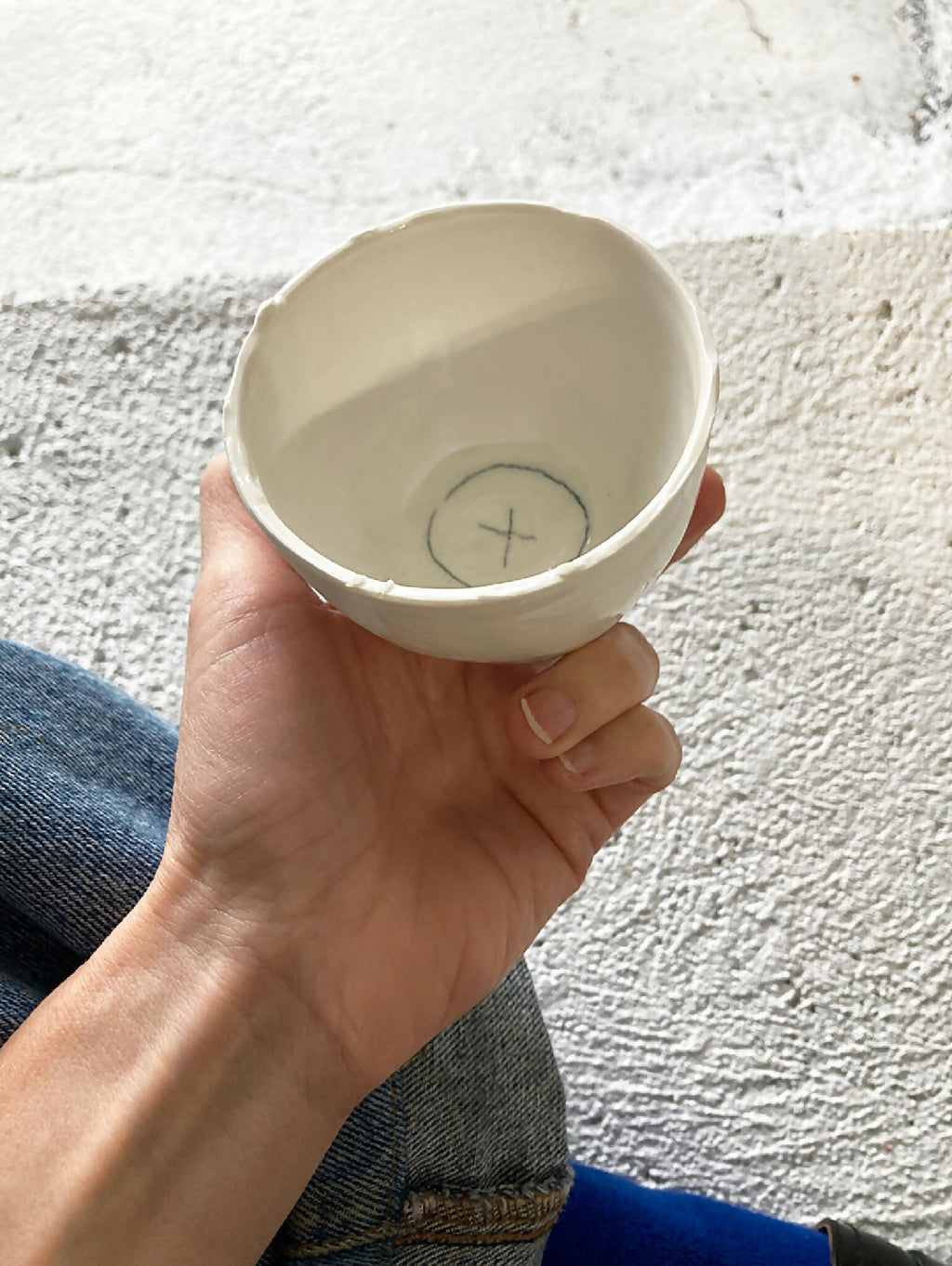 Tasse en porcelaine blanche, vue intérieure avec symbole en forme de croix