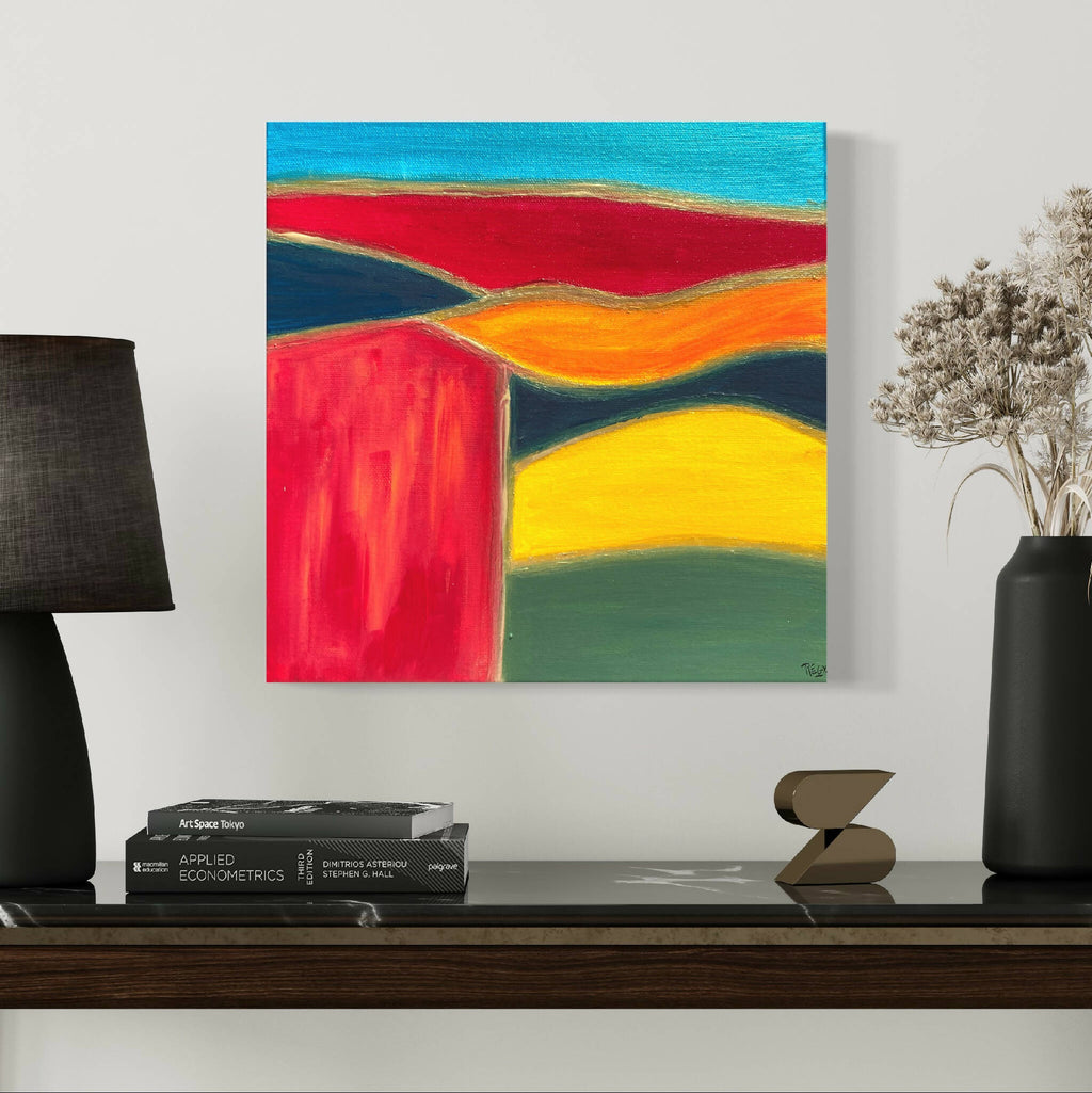 Tableau carré de paysage abstrait aux formes rouges, orange et vert avec bord bleu