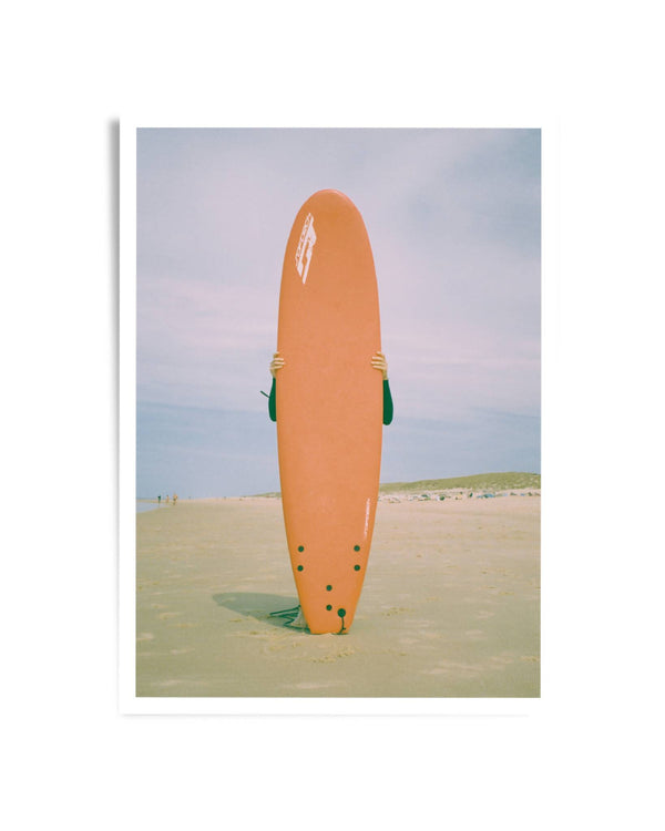 Photographie d’art : planche de surf orange sur une plage, vue de dos