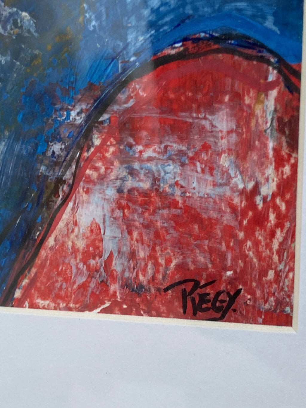 Tableau abstrait encadré, gros plan rouge et bleu texturé, signature en bas.